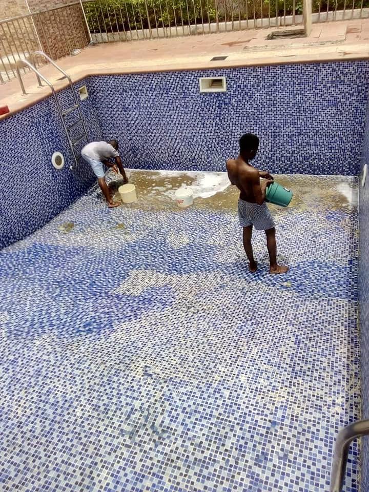 Technician cleaning and maintaining a swimming pool